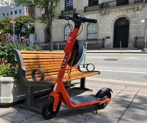 Electric scooter near a public bench